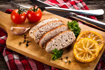 Fried chops and vegetables on cutting board 