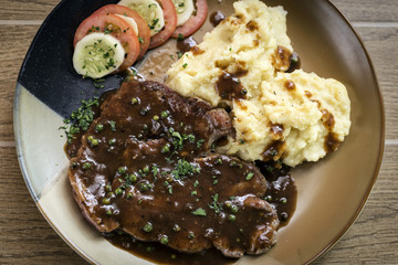 beef steak meal with mashed potato and gravy sauce