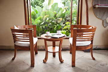 Two cups of coffee on restaurant terrace with afternoon sunlight
