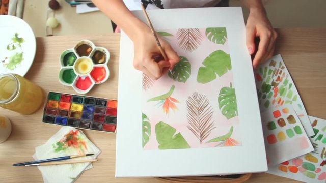 A young woman draws a pattern. Time lapse