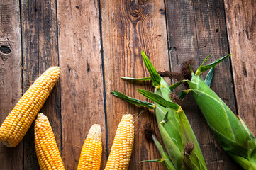 Fresh corn on wooden background. Top view. Copyspace