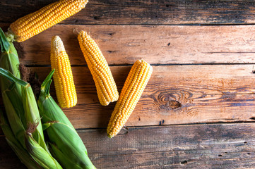 Fresh corn on wooden background. Top view. Copyspace