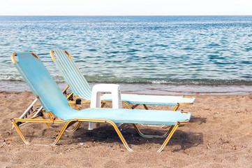 Two chaise longues on the beach