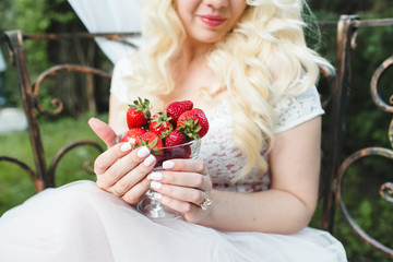 strawberry in hands of the bride
