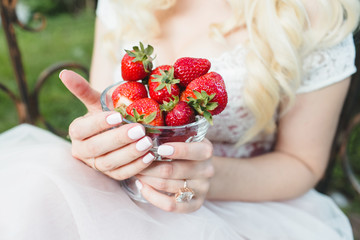 strawberry in hands of the bride