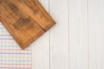 an old cutting board in the kitchen napkin on white wooden table