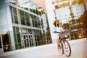 Fototapeta na wymiar Beautiful woman using bike