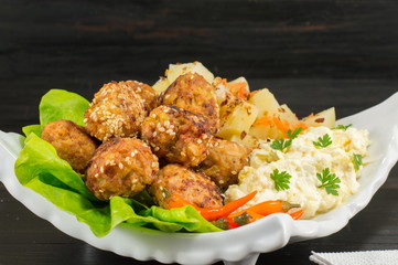 Meatballs on a plate decorated with vegetables