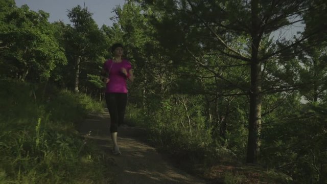 fitness woman running at forest trail