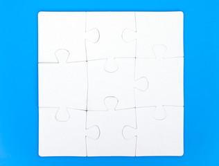 Eight pieces of puzzle are connected together on blue background