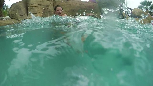 Girl with mom swimming in a pool