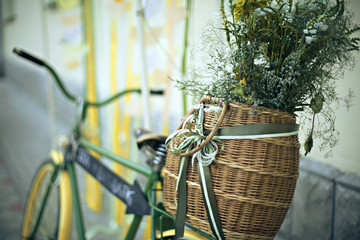 Vintage green bicycle with flower in basket