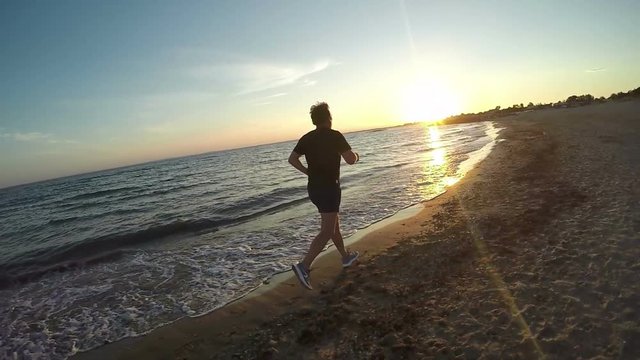 Men jogging on the beach the evening