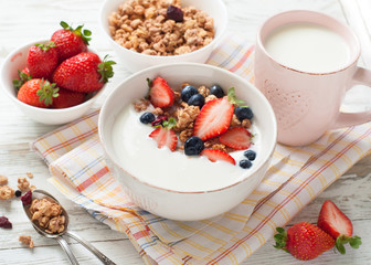Yogurt with granola and berries.