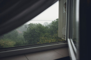 Fototapeta na wymiar Open window in the rainy weather