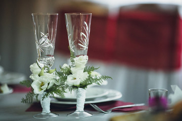 Two crystal goblets with flowers for the newlyweds