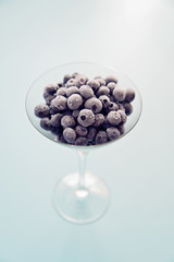 Freshly frozen blueberries in the glass bowl ready to be used in healthy smoothy.  - 120272573