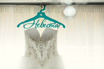 Bridal dress hanging on the cornice