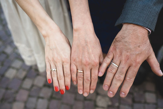 two female hands and one man's hand