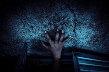 Hands of devil try to get out of the door,Horror background for halloween concept and movie poster...