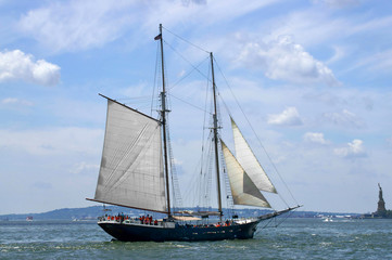 Fototapeta na wymiar Sailing ship on background of Liberty Island