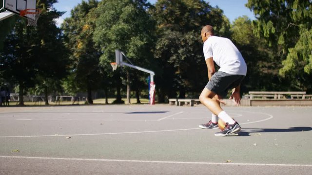  Basketball player dribbling and driving to the basket, in slow motion