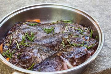 Fresh marine ruff with spices in a pan, close up
