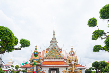 Entrance to Wat Arun buddhist temple,Wat Arun Ratchawararam or the Temple of Dawn. Thailand iconic decorated by ceramics ,Giant statue in wat arun bangkok thailand ,Amazing Thailand