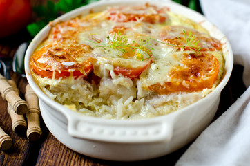 Casserole with rice, sea bass, tomato and cheese