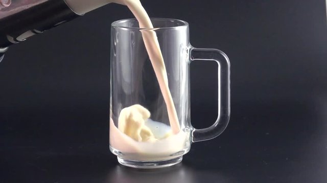 Milk pouring into glass shooting with high speed camera