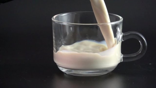 Milk pouring into glass shooting with high speed camera