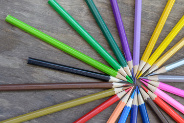 Fototapeta premium Color pencils on the old wood background