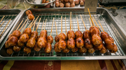 Vender selling sausage thai style local market at temple in Bangkok , Asia , Thailand