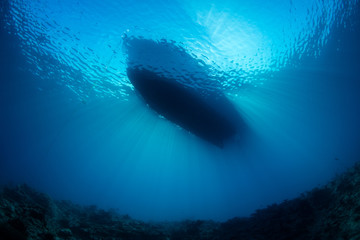 Small Boat Floating in Blue Water