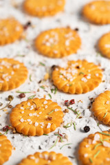 Salted crackers on white wood background