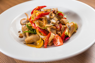 salad with mushrooms on white plate