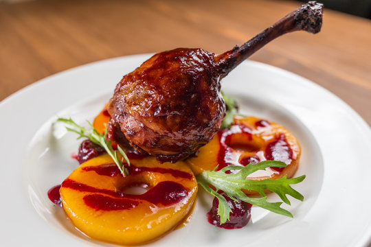 Duck confit on white plate
