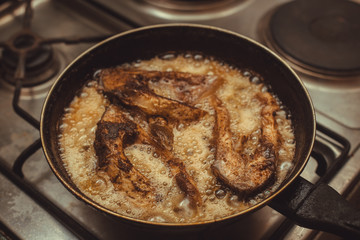 fish frying in a pan