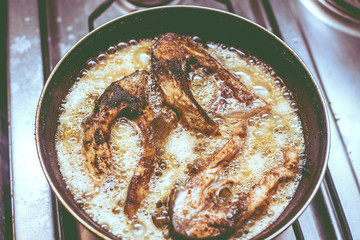 fish frying in a pan