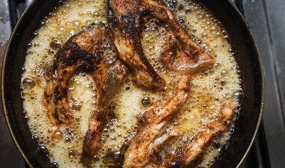 fish frying in a pan