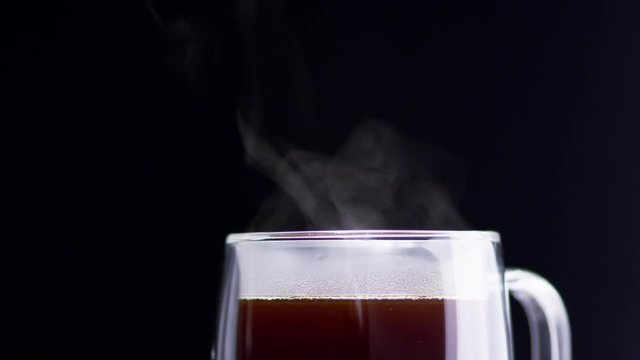 Glass Mug Full of Steaming Dark Coffee