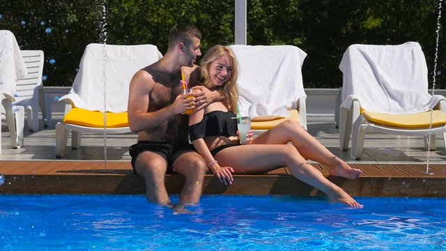 Young couple are relaxation near the swimming pool
