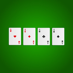 Four aces. Playing cards isolated on green background.