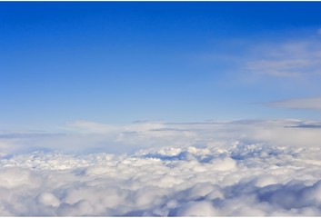 Over clouds. Top view. continuous carpet of clouds against a blue sky