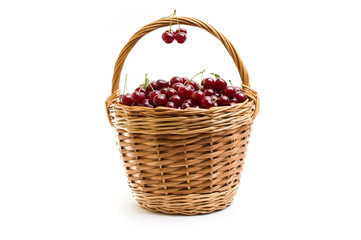 Basket full of fresh red cherry on a white background