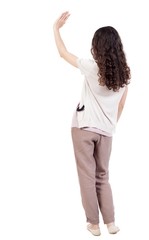 Back view of curly woman welcomes. Young teenager girl hand waving from. Rear view  people collection.  backside view of person.  Isolated over white background. Curly girl waving good-bye.