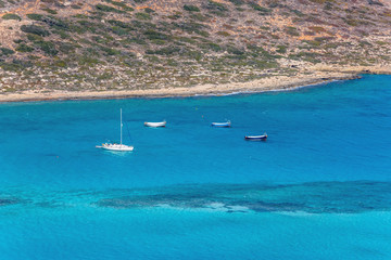Four boats in lagoon of Balos. Crete. Greece.