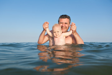 Portrait of daughter and father in the sea