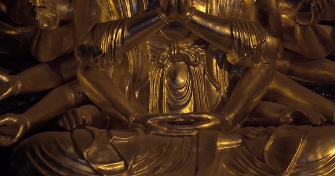 Tilt shot of Buddhist statue Quan Am. Bronze image in Bai Dinh Temple, Vietnam