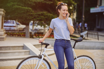 Fototapeta na wymiar girl with Bicycle talking on the phone